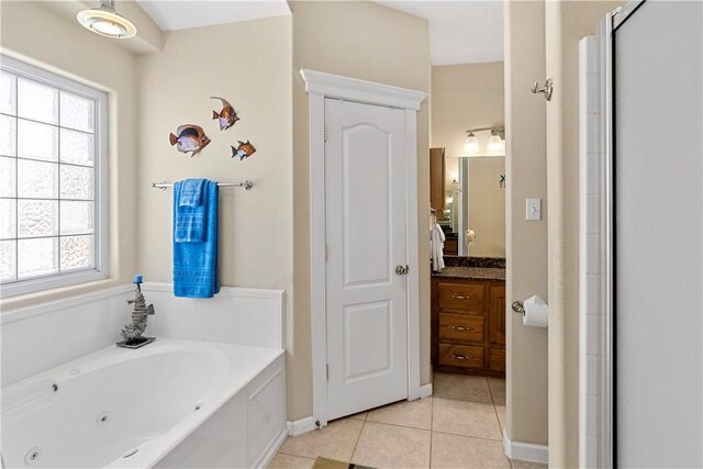 bathroom featuring tile patterned flooring, shower with separate bathtub, and vanity