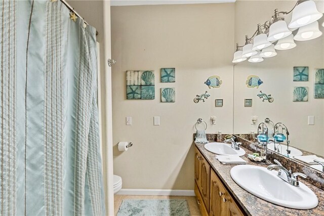 bathroom with vanity, walk in shower, tile patterned flooring, and toilet