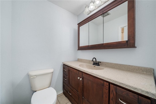 bathroom featuring tile patterned flooring, vanity, and toilet