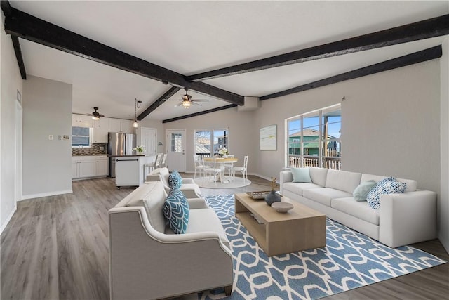 3345 Laguna Shores Rd, Corpus Christi, TX 78418 - living area featuring ceiling fan, light wood-style floors, baseboards, and beamed ceiling