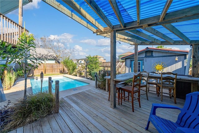 view of swimming pool featuring a pergola, a bar, and a wooden deck