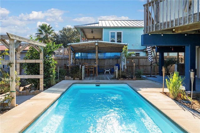 view of pool featuring an outdoor bar and a wooden deck