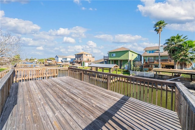 wooden terrace featuring a water view