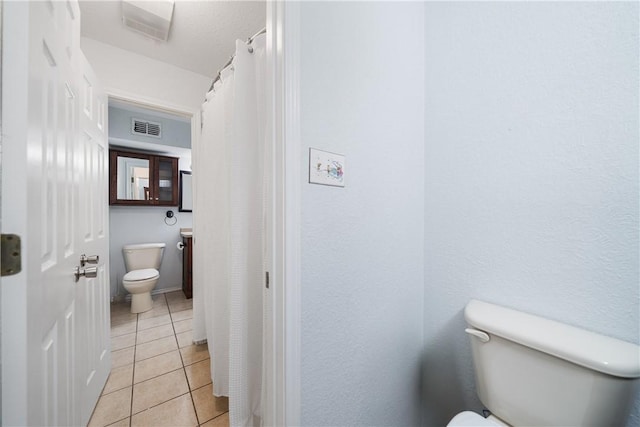 bathroom featuring tile patterned floors and toilet