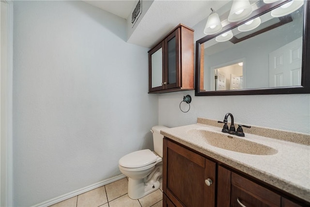 bathroom featuring toilet, vanity, and tile patterned floors