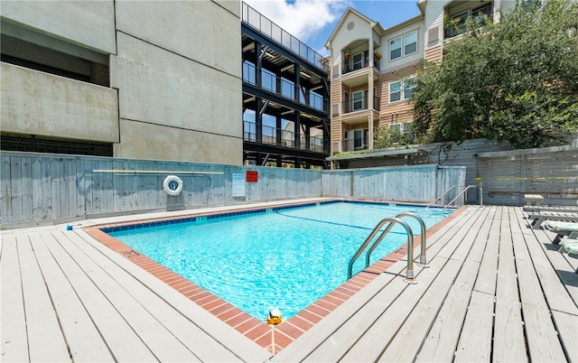 view of swimming pool with a wooden deck