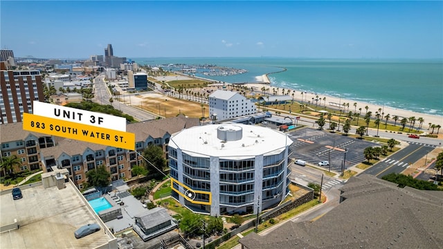 aerial view with a water view and a beach view