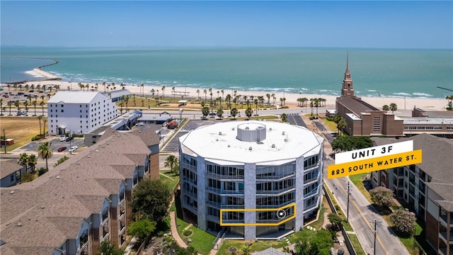 drone / aerial view with a water view and a view of the beach