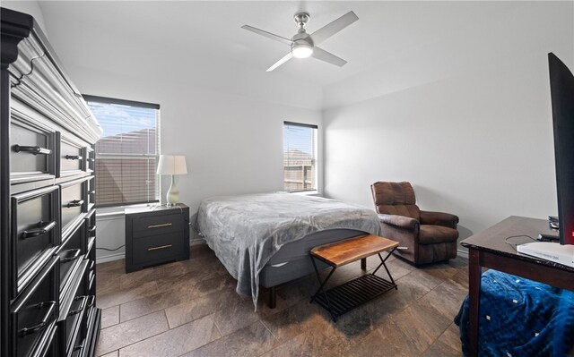 bedroom with ceiling fan and multiple windows