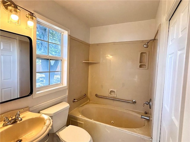 bathroom with  shower combination, a wealth of natural light, a sink, and toilet