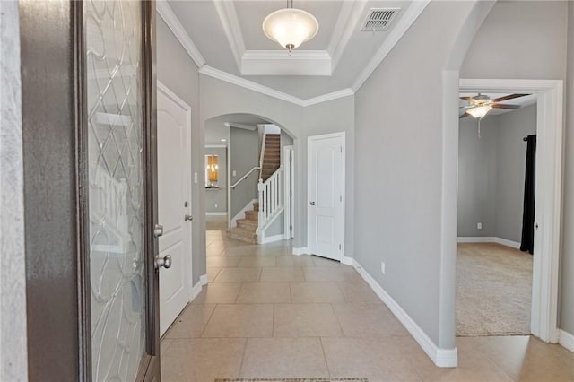 3013 Neches Dr, Corpus Christi, TX 78414 - entryway with arched walkways, baseboards, ceiling fan, a tray ceiling, and light tile patterned floors