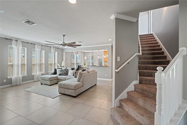 3013 Neches Dr, Corpus Christi, TX 78414 - living room with ceiling fan, light tile patterned floors, baseboards, stairs, and crown molding