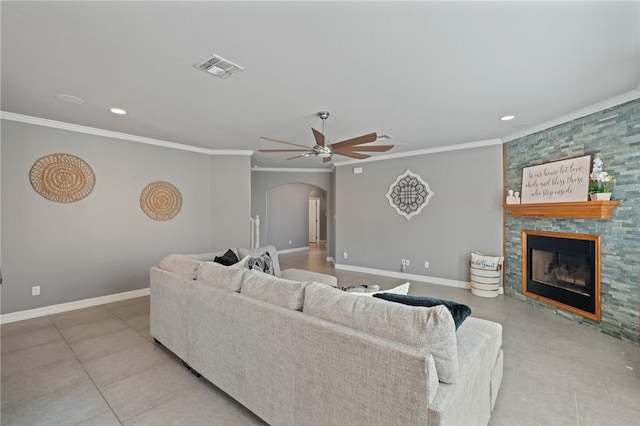 3013 Neches Dr, Corpus Christi, TX 78414 - living room with arched walkways, ceiling fan, a fireplace, ornamental molding, and baseboards