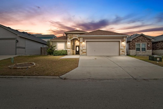 view of front of home with a garage and a lawn