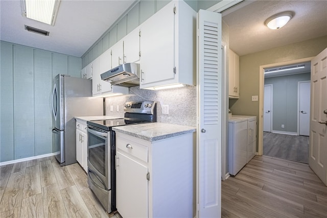 kitchen featuring washer and clothes dryer, white cabinets, stainless steel appliances, and light wood-type flooring