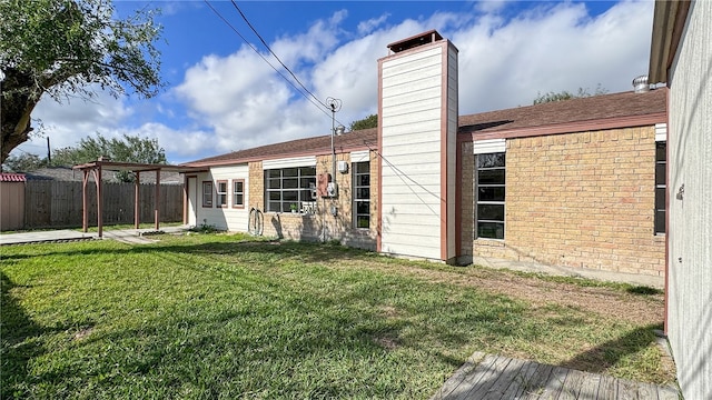 back of house featuring a lawn