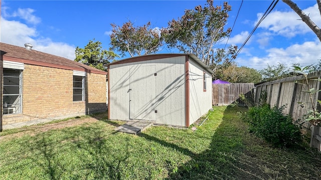 view of outbuilding featuring a lawn