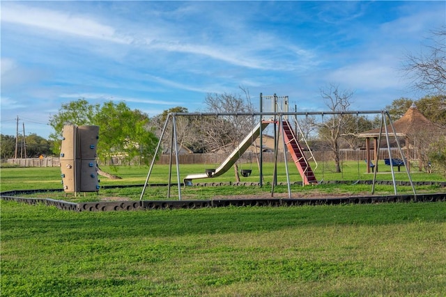 view of playground with a lawn