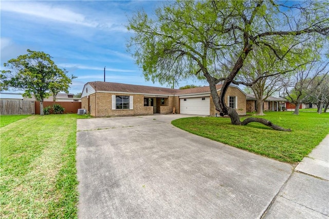 ranch-style home featuring a garage, central AC, and a front yard