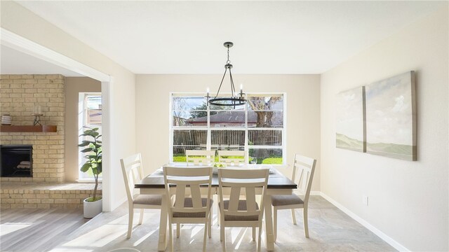 dining room with a fireplace and a chandelier