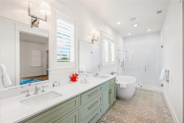 bathroom featuring tile patterned floors, vanity, and shower with separate bathtub