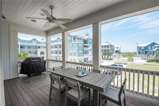 sunroom / solarium featuring ceiling fan, plenty of natural light, and wood ceiling