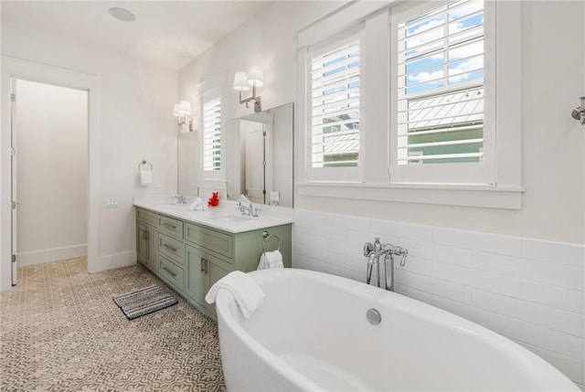 bathroom featuring tile patterned floors, a bathing tub, and vanity