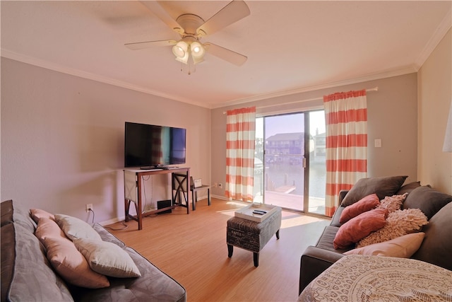 living room with ornamental molding, light hardwood / wood-style flooring, and ceiling fan