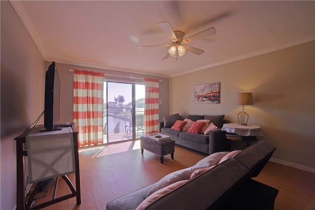 living room featuring ceiling fan, wood-type flooring, and crown molding