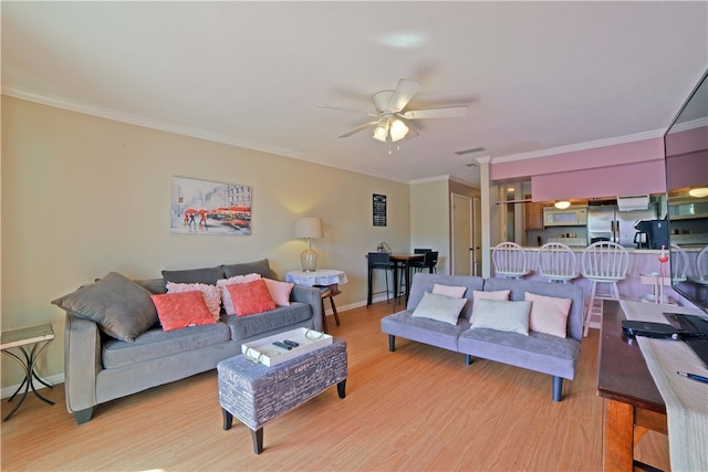 living room with light wood-type flooring, ceiling fan, and crown molding