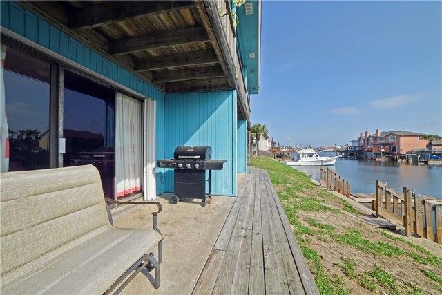 15426 Fortuna Bay Dr Unit 103, Corpus Christi, TX 78418 - wooden deck with area for grilling, a water view, and a boat dock