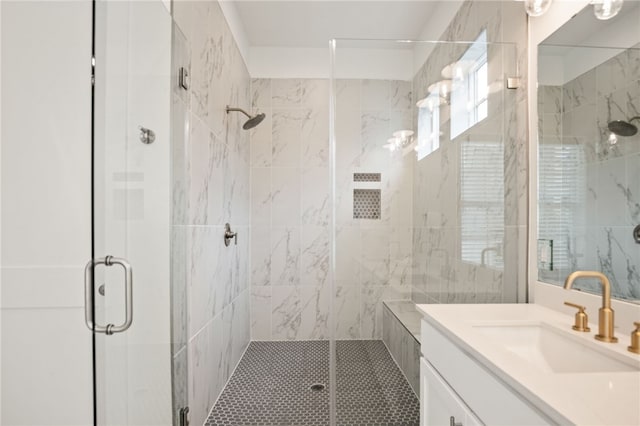 bathroom with a stall shower and vanity