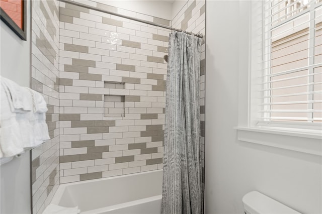 full bath featuring shower / tub combo and toilet