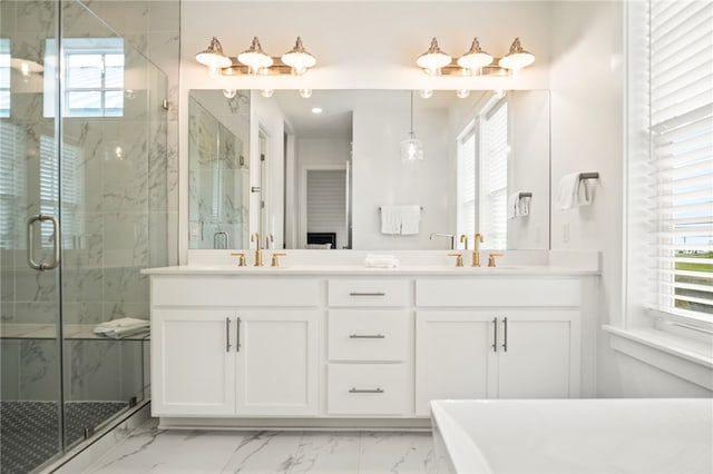 full bathroom with marble finish floor, a stall shower, and a sink