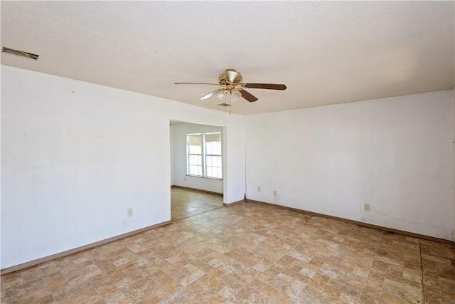 2407 David St, Corpus Christi, TX 78405 - empty room with ceiling fan, stone finish floors, and a textured ceiling