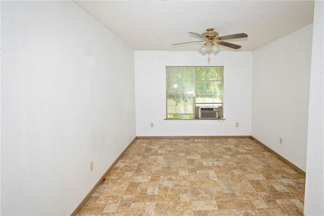 2407 David St, Corpus Christi, TX 78405 - empty room featuring cooling unit, a ceiling fan, stone finish flooring, and a textured ceiling