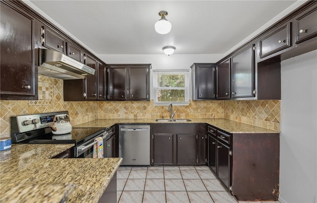 102 Mallard Dr, Aransas Pass, TX 78336 - kitchen with appliances with stainless steel finishes, a sink, under cabinet range hood, decorative backsplash, and light stone counters