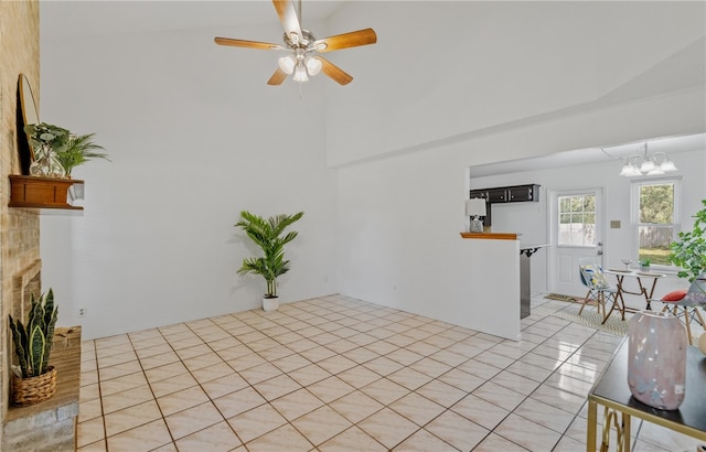 102 Mallard Dr, Aransas Pass, TX 78336 - unfurnished living room featuring a chandelier, a ceiling fan, and a towering ceiling