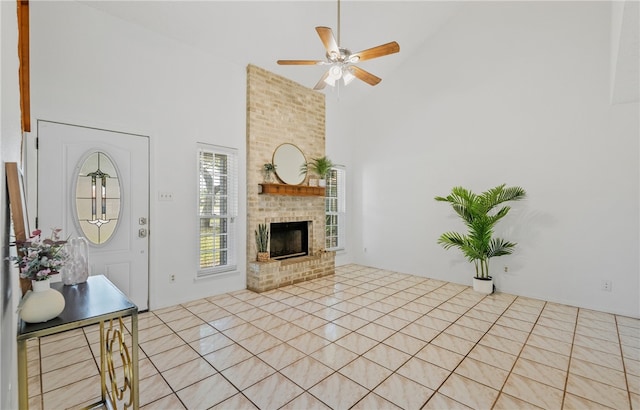 102 Mallard Dr, Aransas Pass, TX 78336 - foyer entrance featuring high vaulted ceiling, a ceiling fan, and a brick fireplace