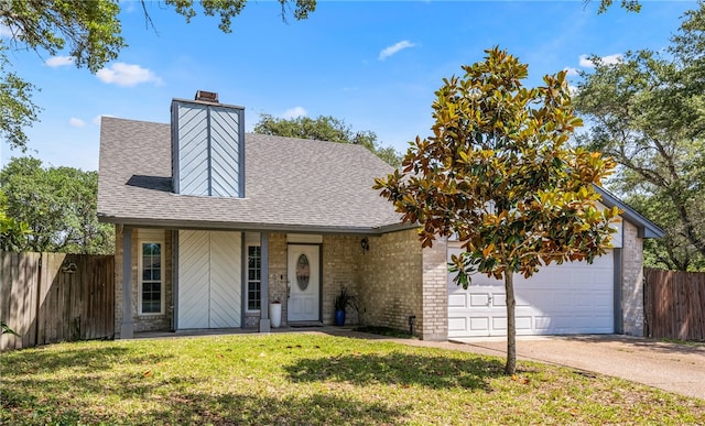 102 Mallard Dr, Aransas Pass, TX 78336 - view of front facade featuring roof with shingles, concrete driveway, a chimney, brick siding, and an attached garage