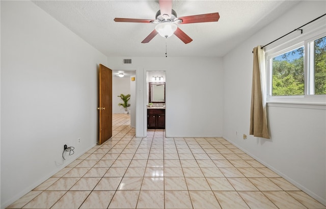 102 Mallard Dr, Aransas Pass, TX 78336 - spare room featuring a ceiling fan, light tile patterned flooring, and a textured ceiling