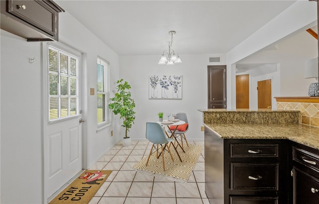 102 Mallard Dr, Aransas Pass, TX 78336 - dining space featuring a chandelier, light tile patterned floors, and baseboards