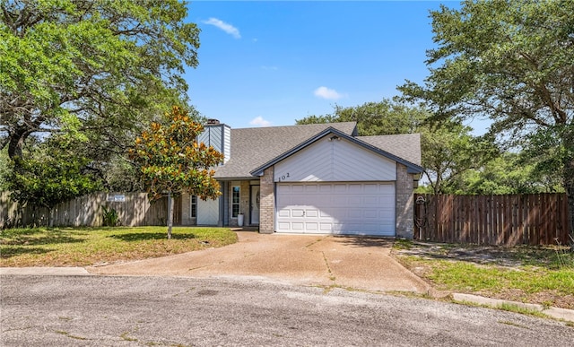 102 Mallard Dr, Aransas Pass, TX 78336 - view of front of home featuring an attached garage, driveway, roof with shingles, brick siding, and a chimney