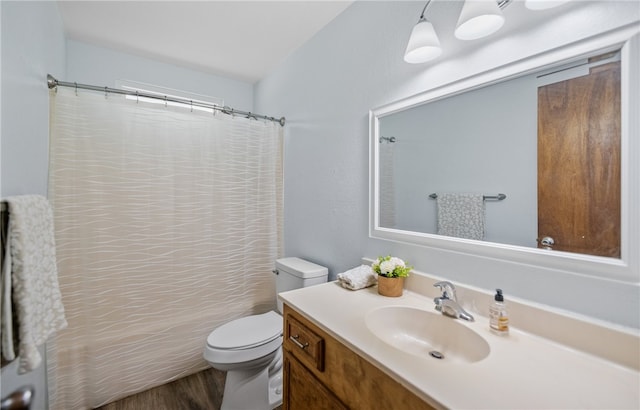 102 Mallard Dr, Aransas Pass, TX 78336 - full bathroom featuring wood finished floors, toilet, vanity, and a shower with shower curtain