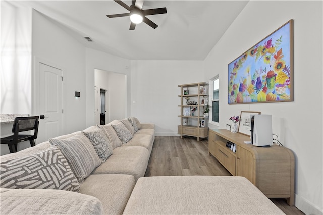 living room with ceiling fan and light hardwood / wood-style flooring