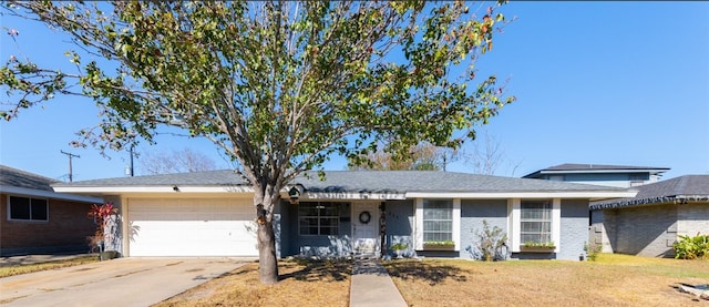 single story home with a garage and a front lawn