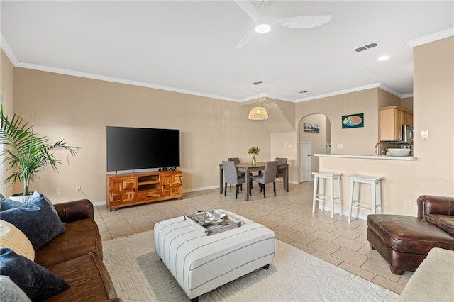 14901 Windward Dr Unit 403, Corpus Christi, TX 78418 - living area featuring arched walkways, light tile patterned floors, ornamental molding, a ceiling fan, and baseboards