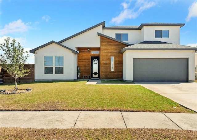 view of front of house with a garage and a front lawn