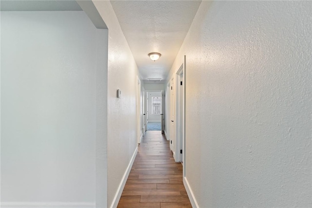 1010 Weber Pkwy, Corpus Christi, TX 78411 - hallway featuring a textured wall and wood finished floors