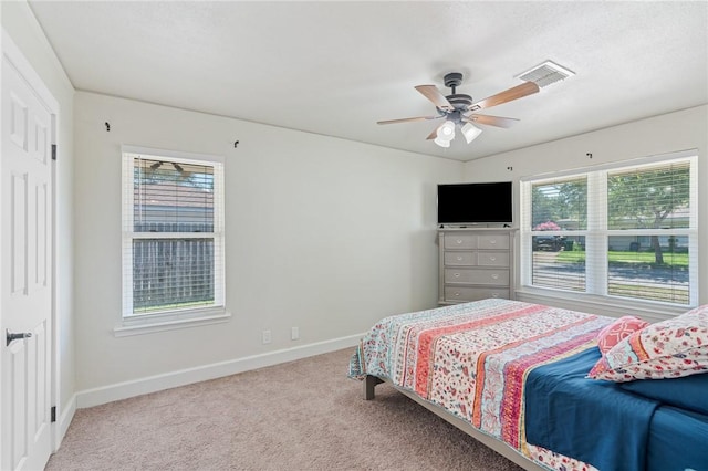 1010 Weber Pkwy, Corpus Christi, TX 78411 - bedroom with multiple windows, carpet floors, and a ceiling fan